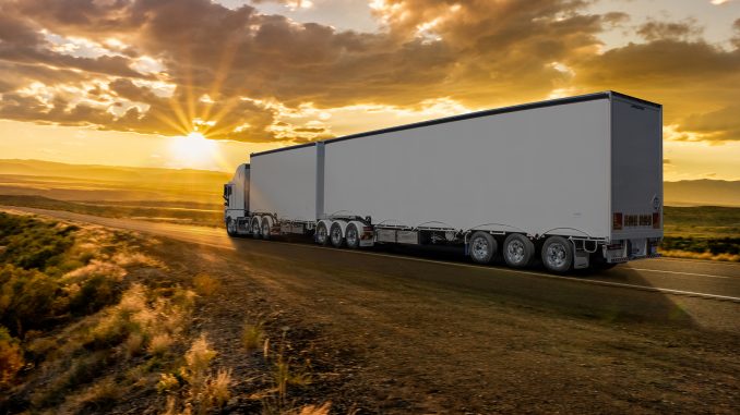 Semi-Truck on an Interstate Highway at Dusk with Cloudscape