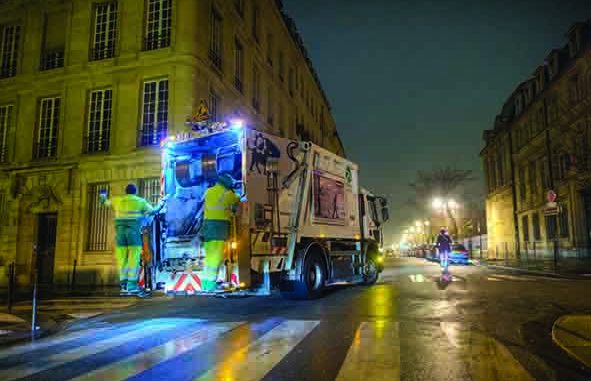 French Refuse Truck with Workers on Back